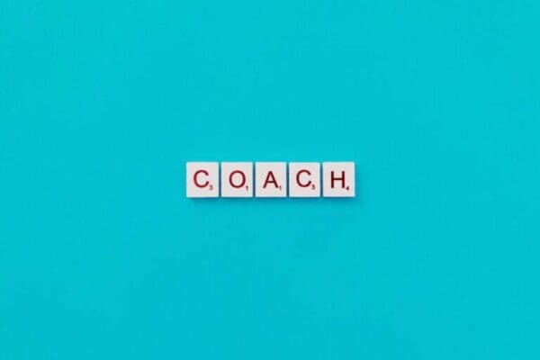 coach spelt on light blue background for coaching conversation