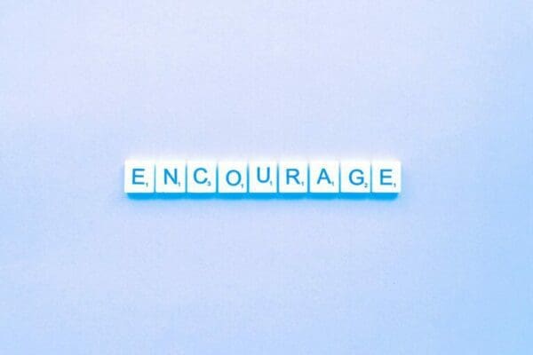 encourage spelled on light blue background