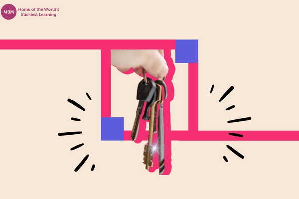 Hand holding a key on pink background