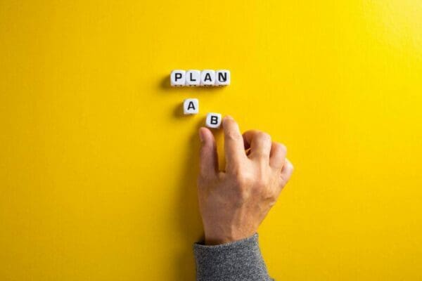 Hand choosing plan a or plan b cubes