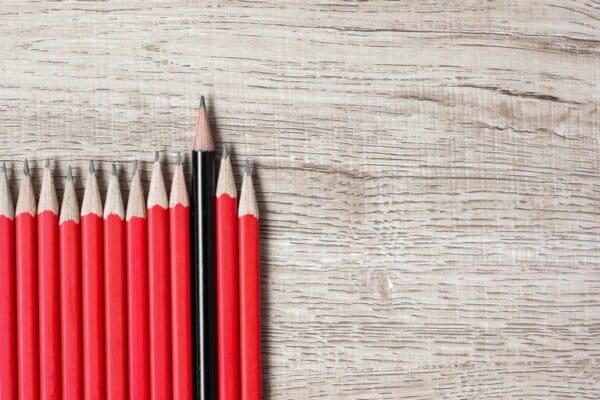 Red pencils with single black pencil standing out to represent neurodiverse