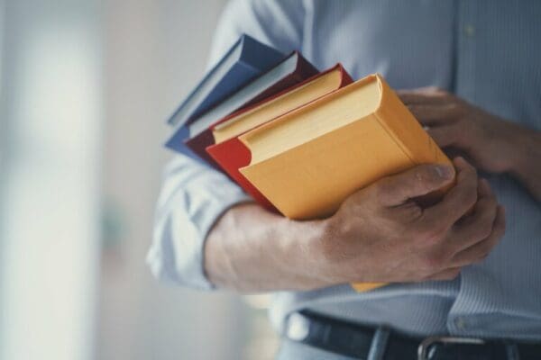 Knowledge worker holding books in hand