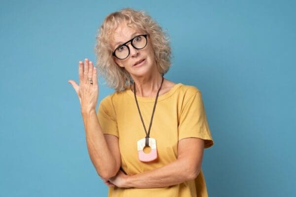 Mature woman showing passive aggressive behaviour with blue background