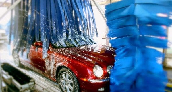 Red car under a car wash