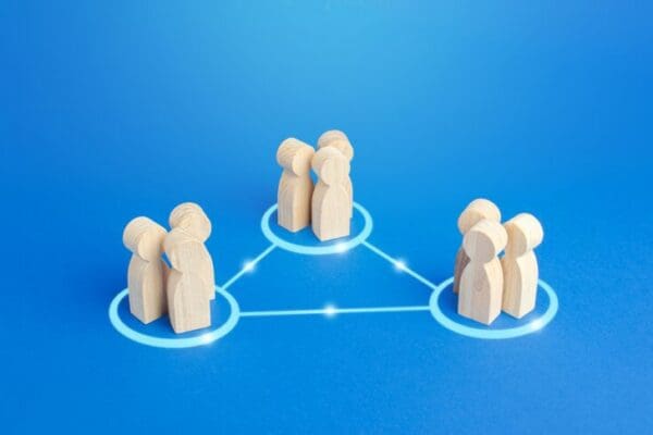 communication model with wooden people figures on blue background