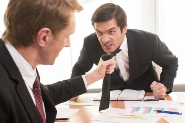 Two male employees managing conflict at work physically