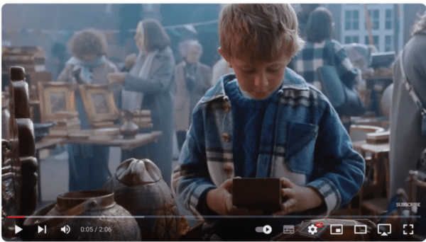 Screenshot from the John Lewis Christmas advert of a little boy buying a grow your own Christmas tree kit.