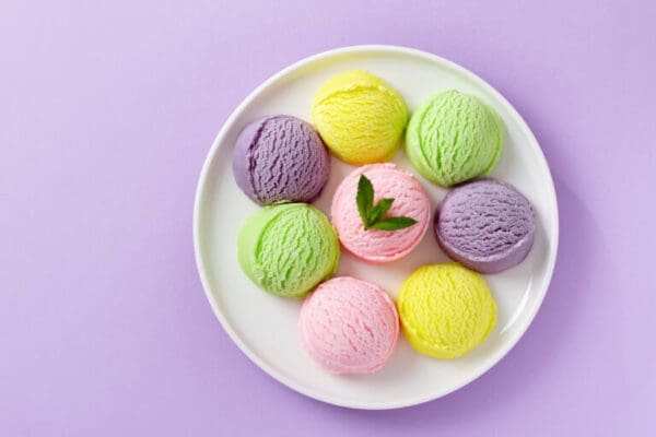 Pastel colored ice cream scoops on white plate