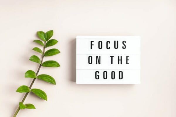 Focus on the good next to geen plant on light pink background