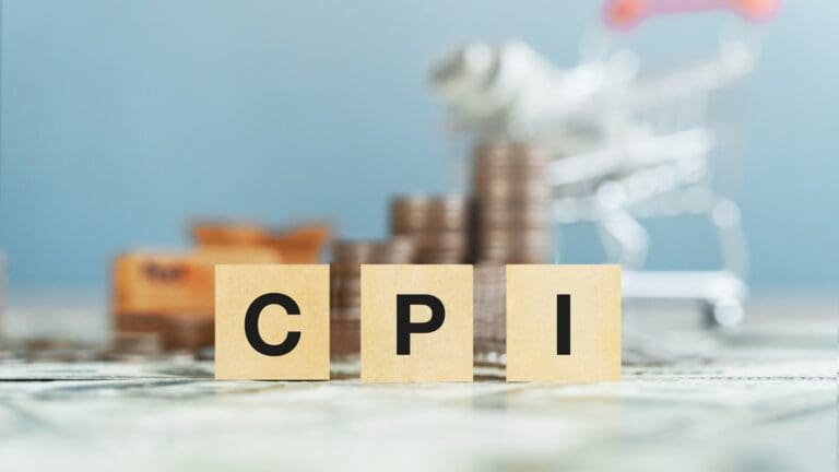 CPI consumer price index text on a wooden block with money in the background