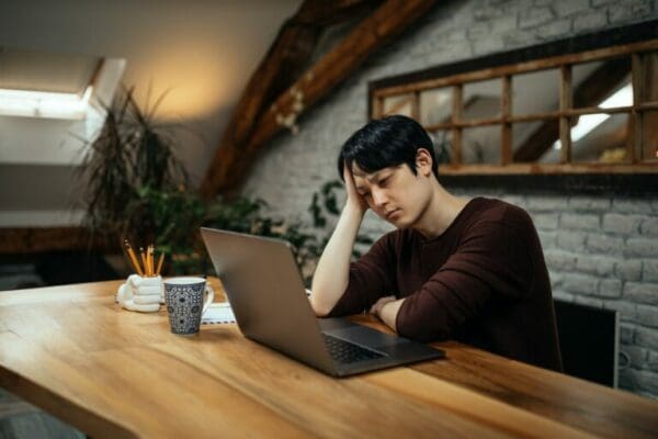 Asian male working from home at kitchen table